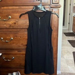 Athleta dress in black with side pockets and a sheer back.